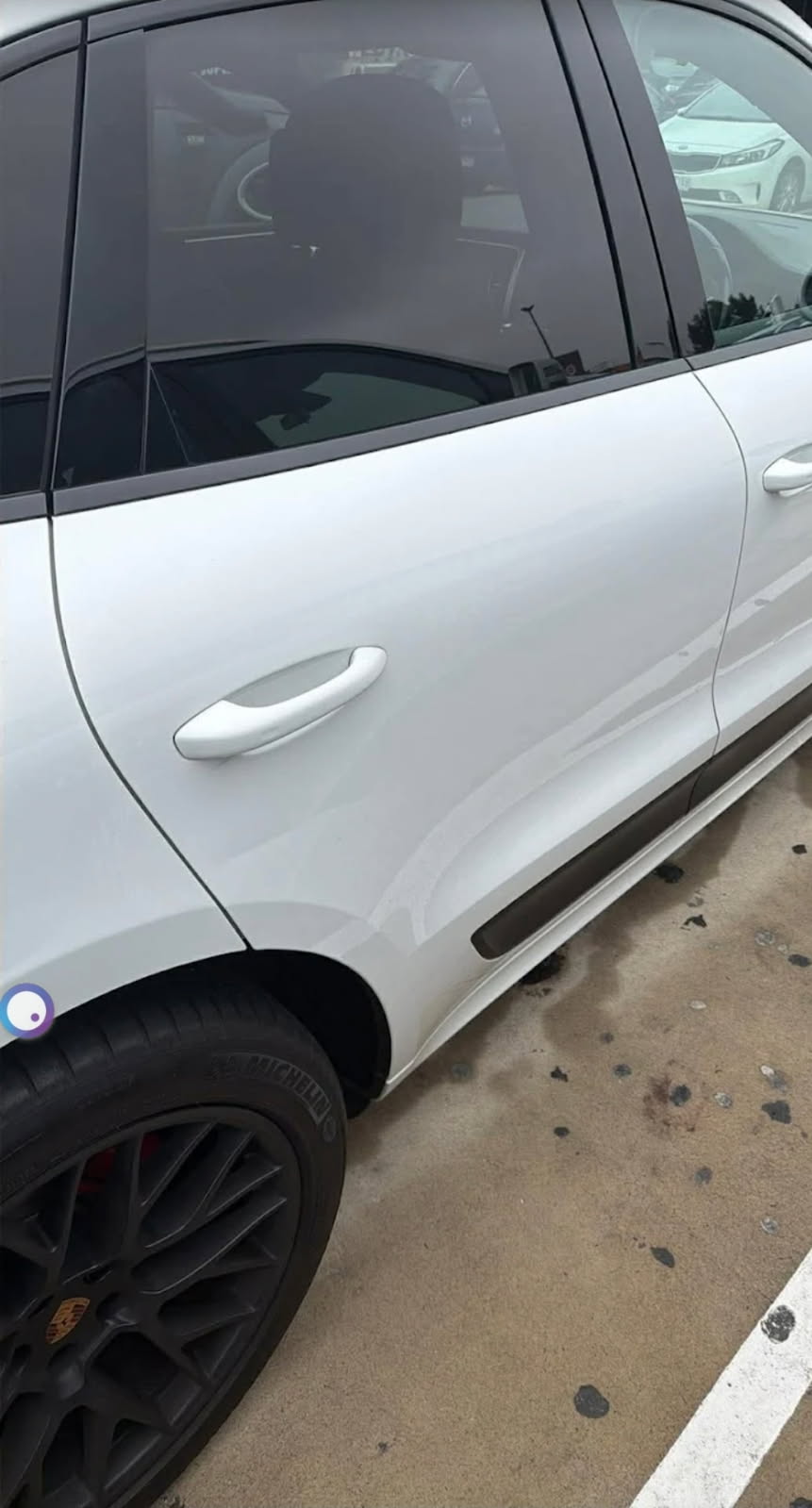 Porsche Macan door dent — before